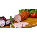 Sliced smoked homemade ham from DELUMANI, a traditional mezeluri product, displayed on a platter with a rustic presentation.