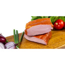 Slices of homemade DELUMANI pork pastrami, showing marbled meat and seasoned, cured pork slices on a wooden surface.